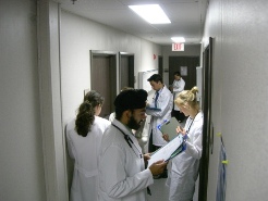 Quarter 3 students in Modular E hallway reading presenting information