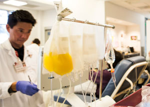 Manny Dy, Apheresis Technician, with platelets that can be used to treat cancer patients, bone marrow transplant patients, trauma victims, and patients with blood disorders.