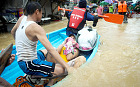 Residents riding plastic boats seek higher ground after continued monsoon rains triggered by tropical storm Fung-Wong have inundated parts of Marikina in Manila, Philippines