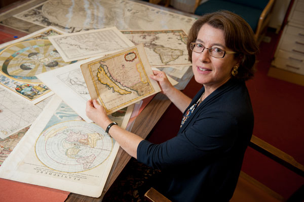 Julie Sweetkind-Singer, head librarian, Branner Earth Sciences Library & Map Collections, with some of the maps depicting California as an island.