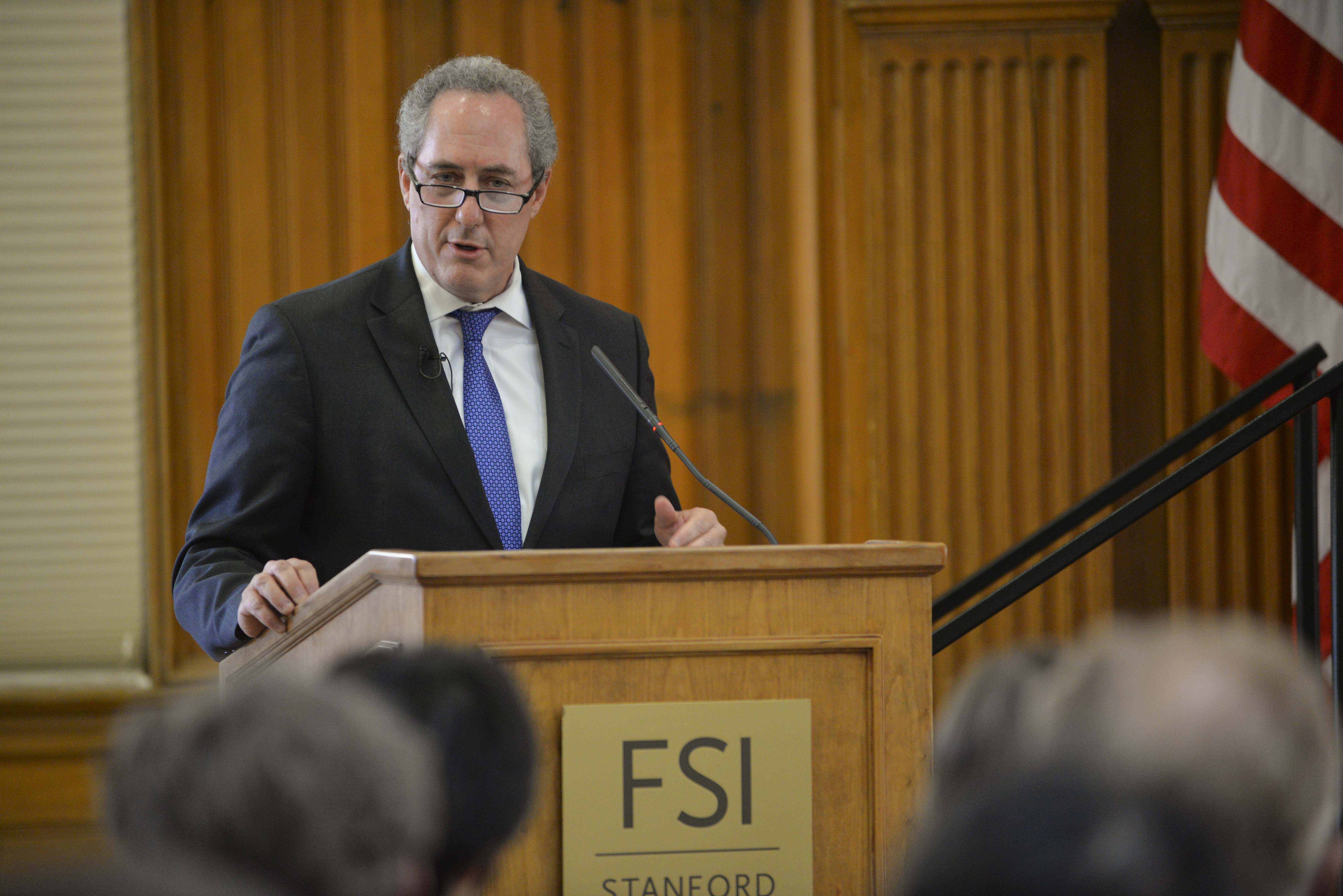 Photo of Michael Froman speaking at a lectern that has an FSI placard.