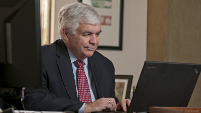 John Taylor works on a laptop at his desk