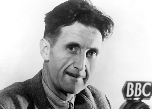 Photo of writer George Orwell holding a microphone