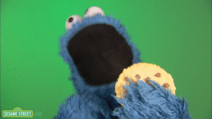 Cookie Monster is eating a cookie with enthusiasm 