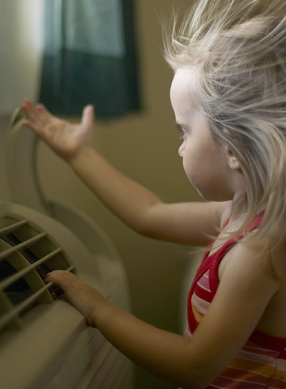 A girl enjoys air-conditioning, one example of a product that uses Chemours fluorochemicals and fluoropolymers