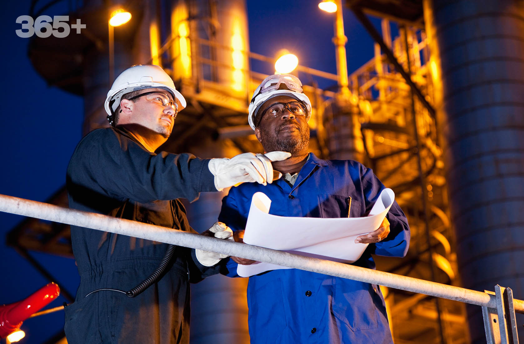 Two men in hardhats look at a blueprint; they symbolize the manufacturing expansion across key businesses for Chemours.