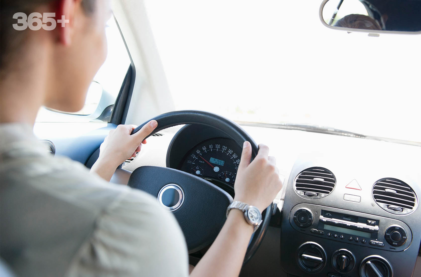 A woman driving a car represents Opteon™ refrigerant cooling benefits.