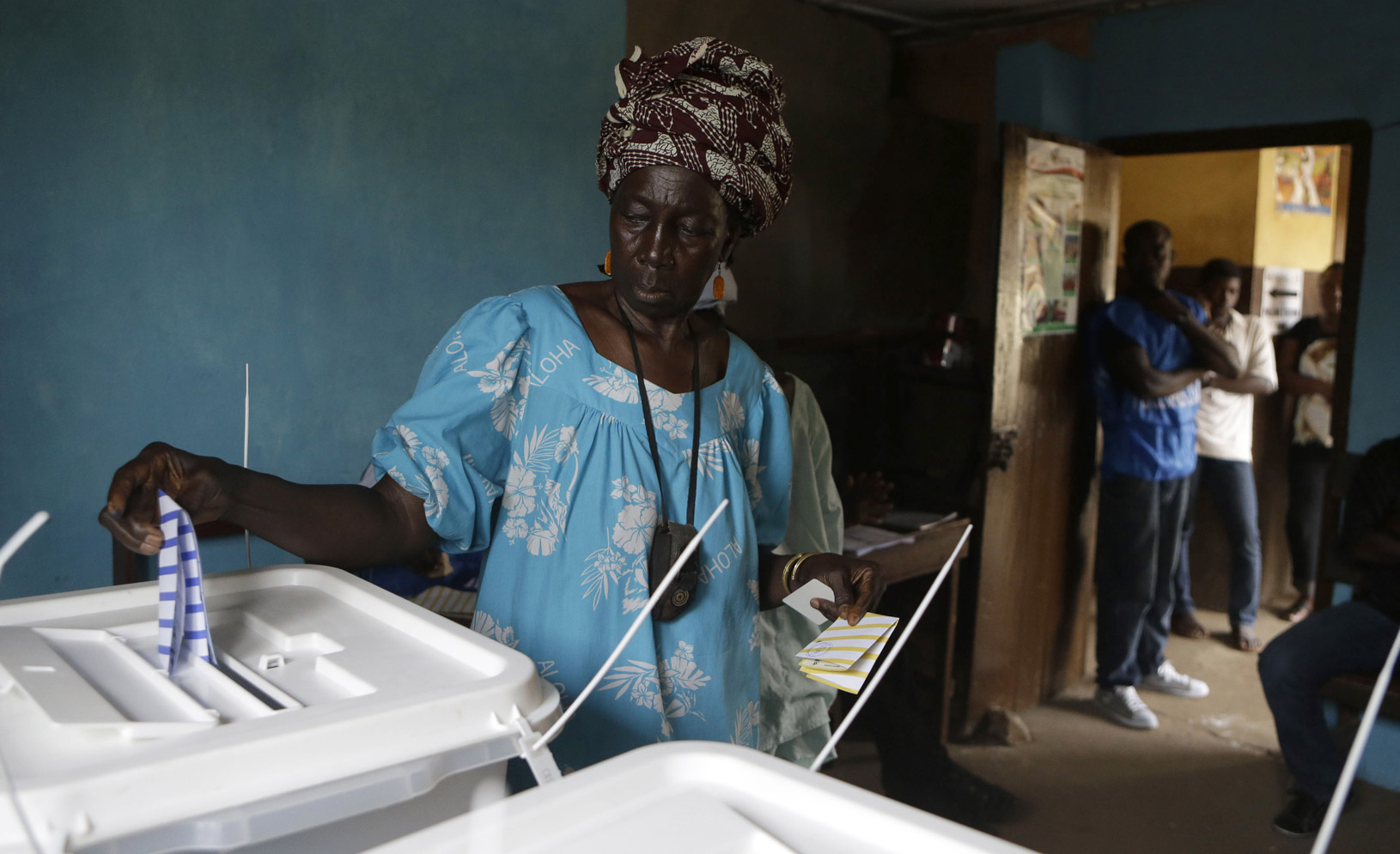 At a polling station in Freetown, Sierra Leone, a woman casts her ballot for president in the November 2012 elections.