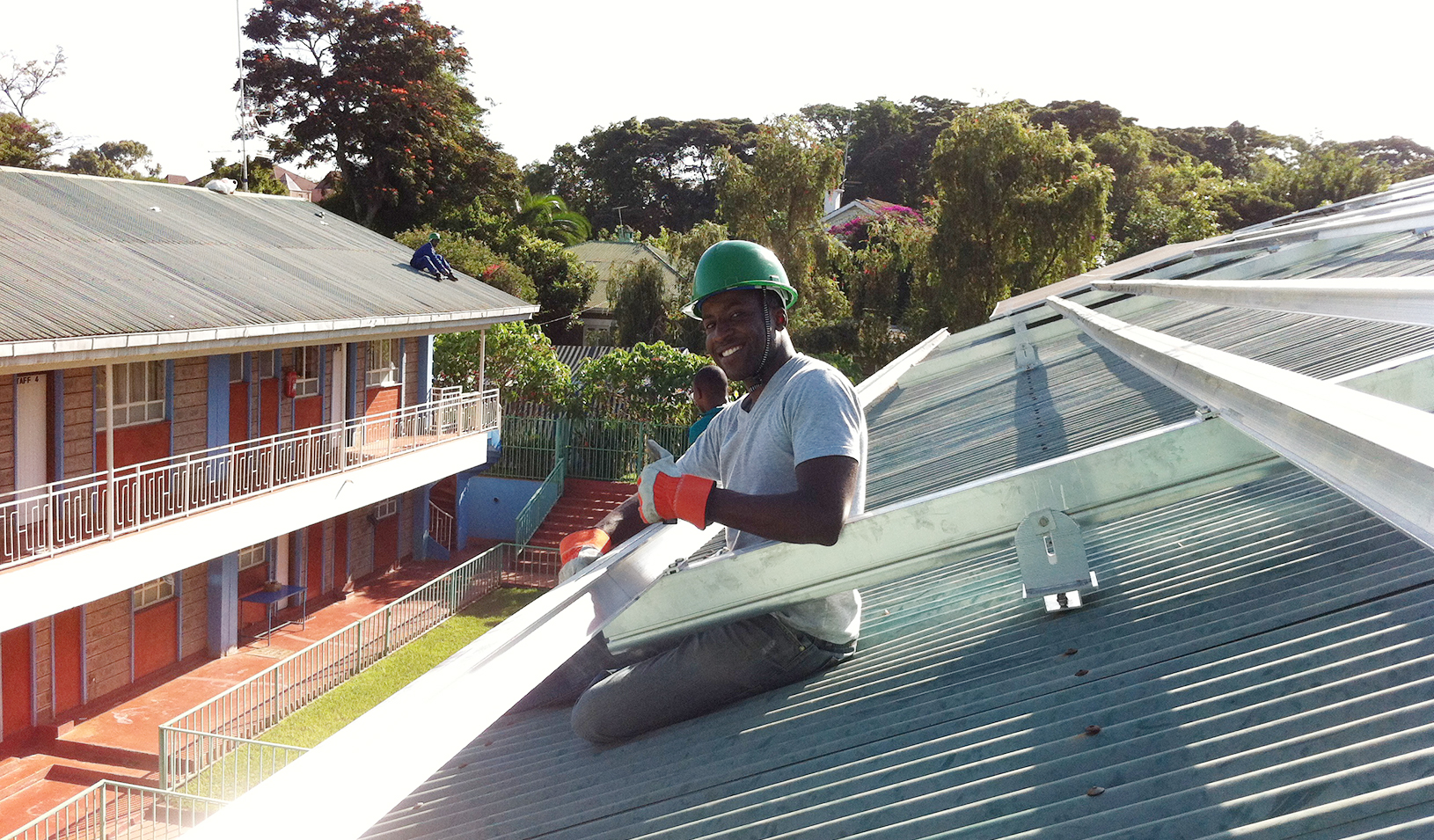 Aurora Co-founder Samuel Adeyemo works on a rooftop installation. | Courtesy of Samuel Adeyemo