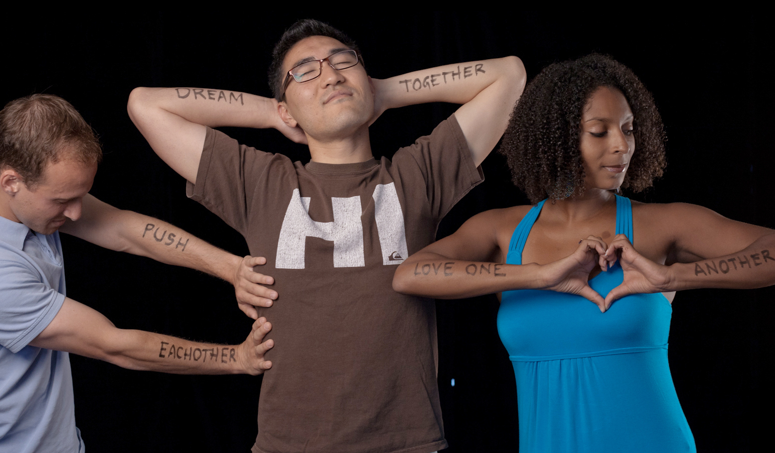 Students with writing on arms: Push each other; Dream together; Love one another