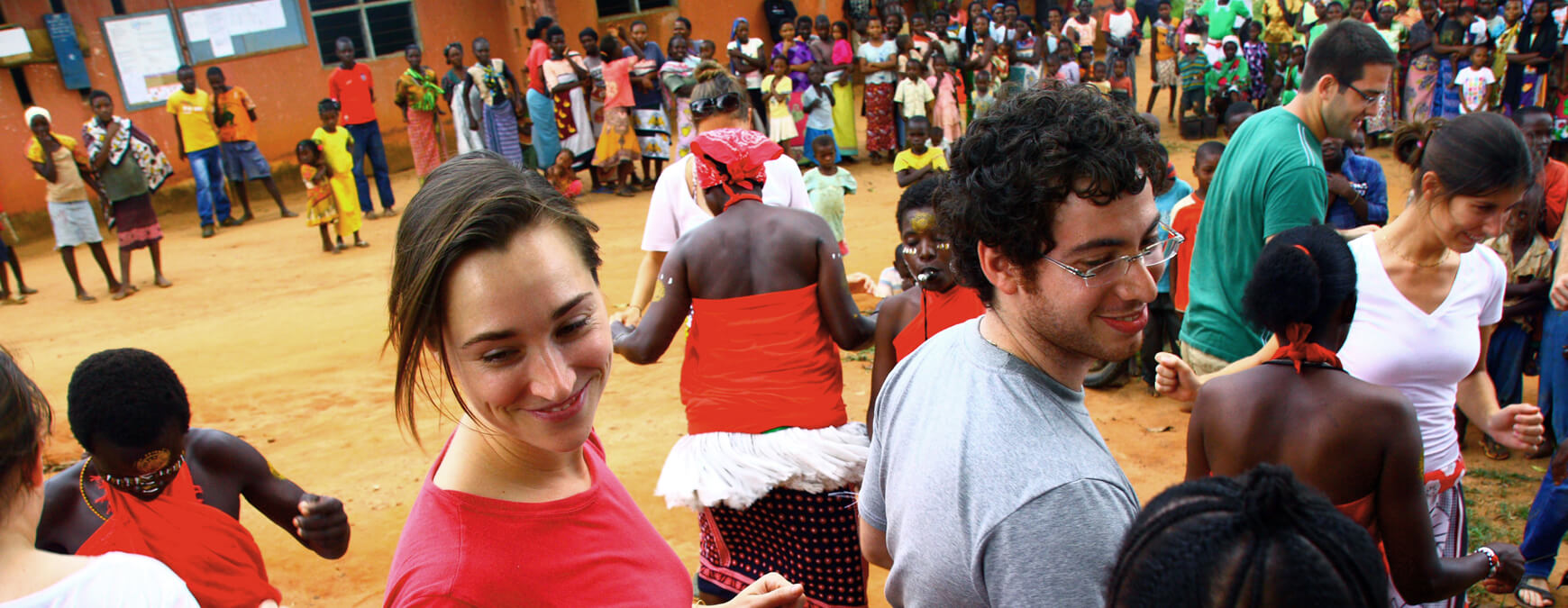 Casey Owens ’13 and Roi Chobadi ’13 join the traditional African dance in Kaloleni, Kenya