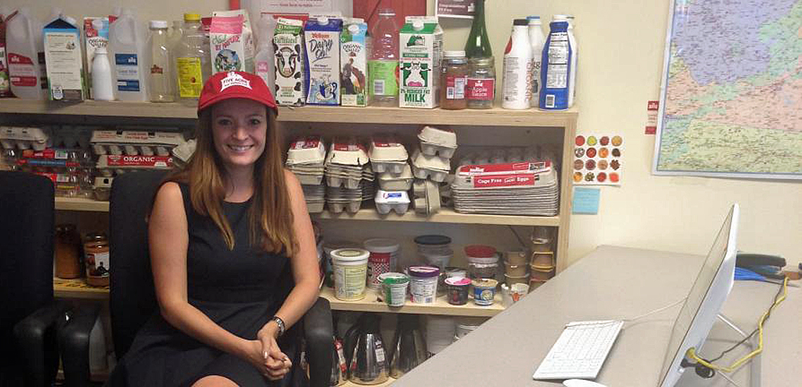 Student seated in office surrounded by dairy products