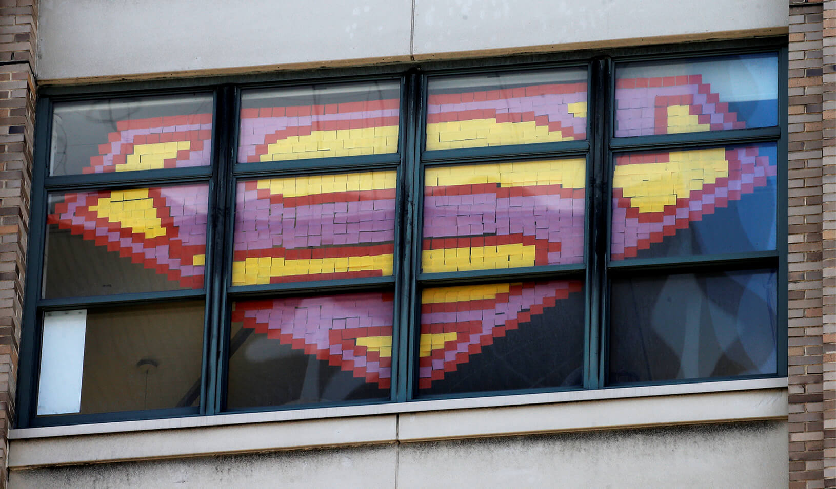 Superman's logo created using sticky notes in a window | Reuters/Mike Segar 