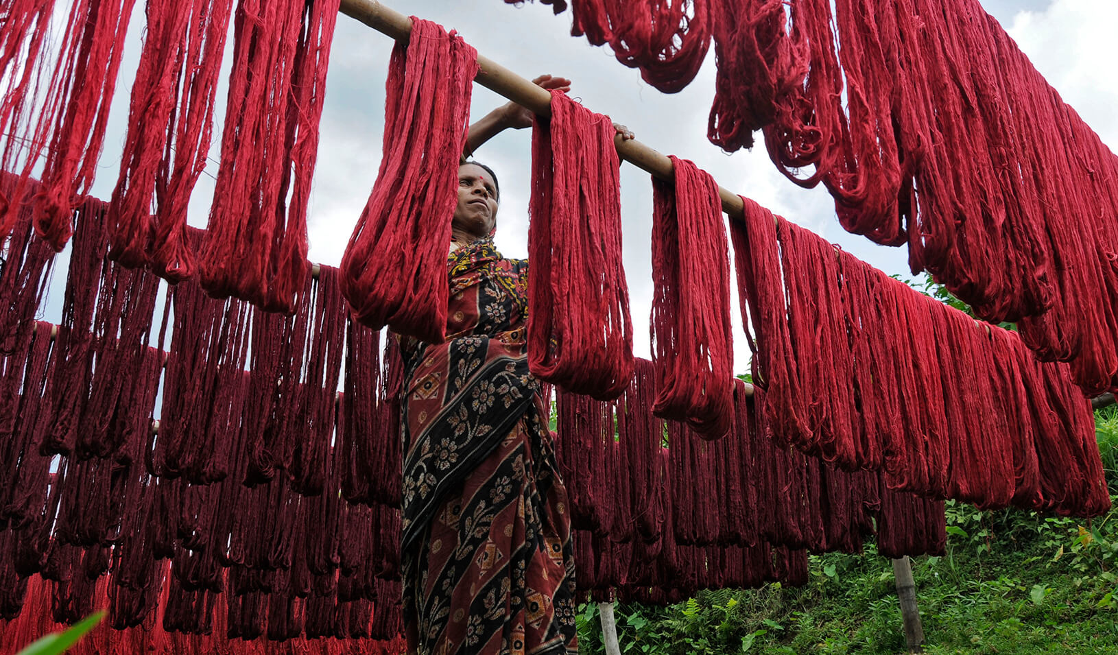 A woman hanging dyed yarn to dry at a textile mill on the outskirts of Agartala | Reuters/Jayanta Dey