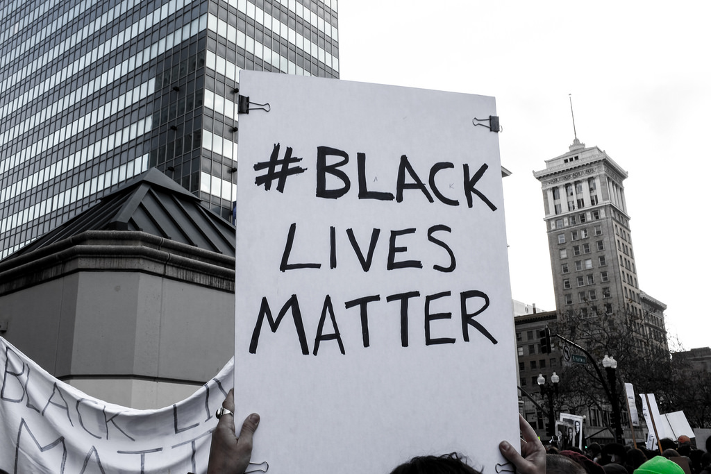 Protest sign: "#BLACKLIVESMATTER", from https://www.flickr.com/photos/82417691@N00/16022084905, License: https://creativecommons.org/licenses/by/2.0/