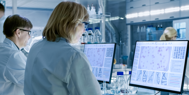 Female and Male Scientists Working On Their Computers