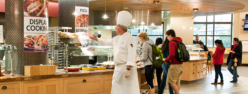 Arillaga Family Dining Commons cafeteria: chef, students and staff near the grill section.