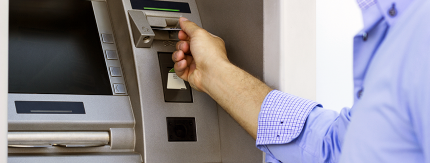 Person putting in card in ATM