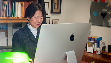 Asian female working at desktop computer