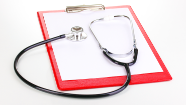 Red clipboard with stethoscope on top.
