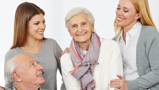 Two female caregivers with an eldery couple.