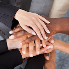 Multiracial business colleagues stacking hands