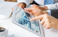 Two people working on laptop and tablet