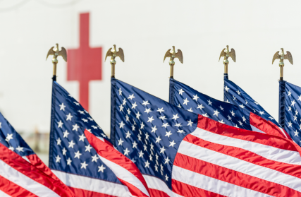 American flags lined up in front of the Red Cross building