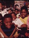 group of black school children wait in a crowded playground