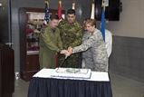 U.S. Air Force General Lori J. Robinson, Commander of the North American Aerospace Defense Command and U.S. Northern Command, Royal Canadian Air Force Lt. Gen. Pierre St-Amand, the NORAD Deputy Commander, U.S. Air Force Staff Sgt. Hillary Melton, and Canadian Army Corporal Alex Loiselle cut the traditional birthday cake during NORAD’s 59th Anniversary cerebration  on Peterson AFB, CO May 12th. (DoD Photo by: N&NC Public Affairs/Released)