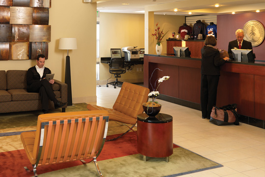 A guest being helped at the front desk of the Stanford Guest House.