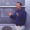 Aabas teaching in front of a blackboard