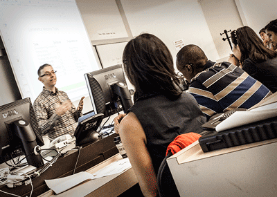 An instructor interacts with attendees in a Techie Fest lecture class on project management.