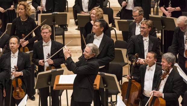 Members of the Stanford Symphony orchestra standing. 