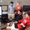 Stanford University PWR instructor Christine Alfano works with students at a collaboration station in one of the tech classrooms in Wallenberg Hall. 