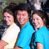 Sophomore College Assistant with two students smiling