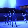 Students dance on a blue-lit stage at Bing Concert Hall