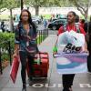 Two students with boxes moving into their dorm. 