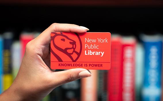 Closeup of someone holding an NYPL library card.