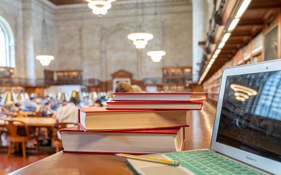 Computer and a stack of books.