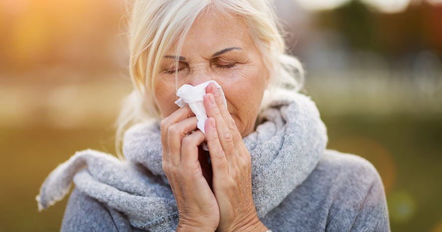 Woman blowing nose