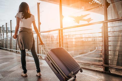 Woman pulling suitcase