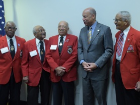 Secretary Johnson enjoys a laugh with members of the Tuskegee Airmen