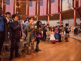Children in costume recite the Pledge of allegiance