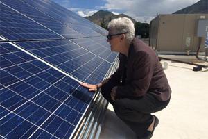EPA Administrator Gina McCarthy inspects a solar panel