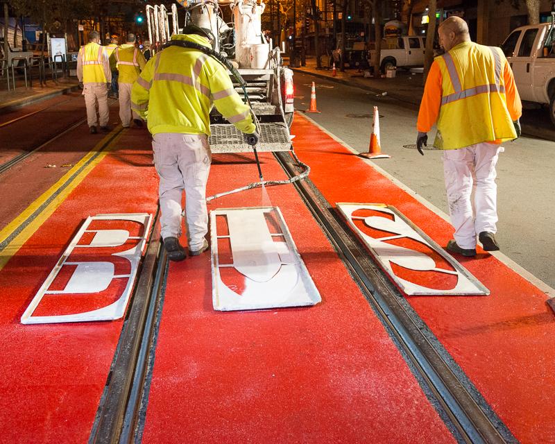 paint crews painting bus lane