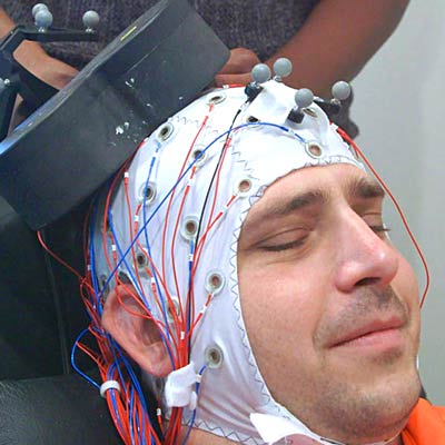 Transcranial magnetic stimulation being used on a graduate student