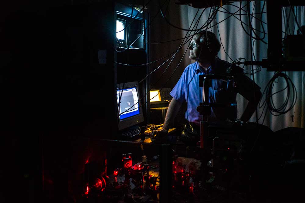W.E. Moerner examines molecules on a screen in his laboratory