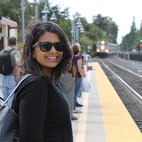 Smiling woman standing on Caltrain platform