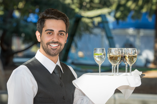 Waiter holding glasses of champagne 